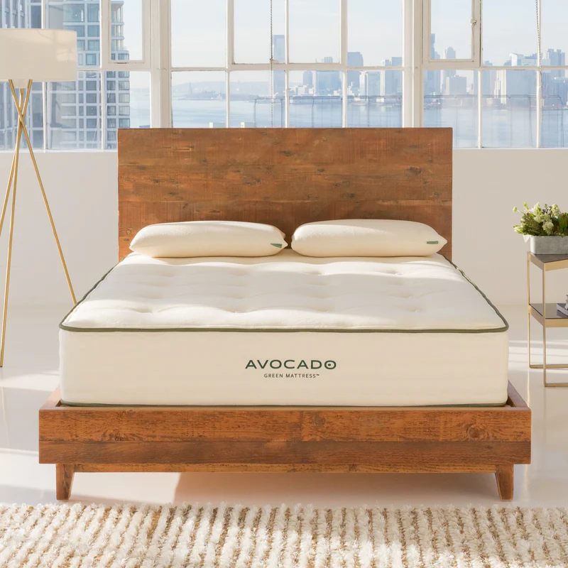Eco-friendly Avocado Green Mattress on a reclaimed wood bed in a bright, serene bedroom.
