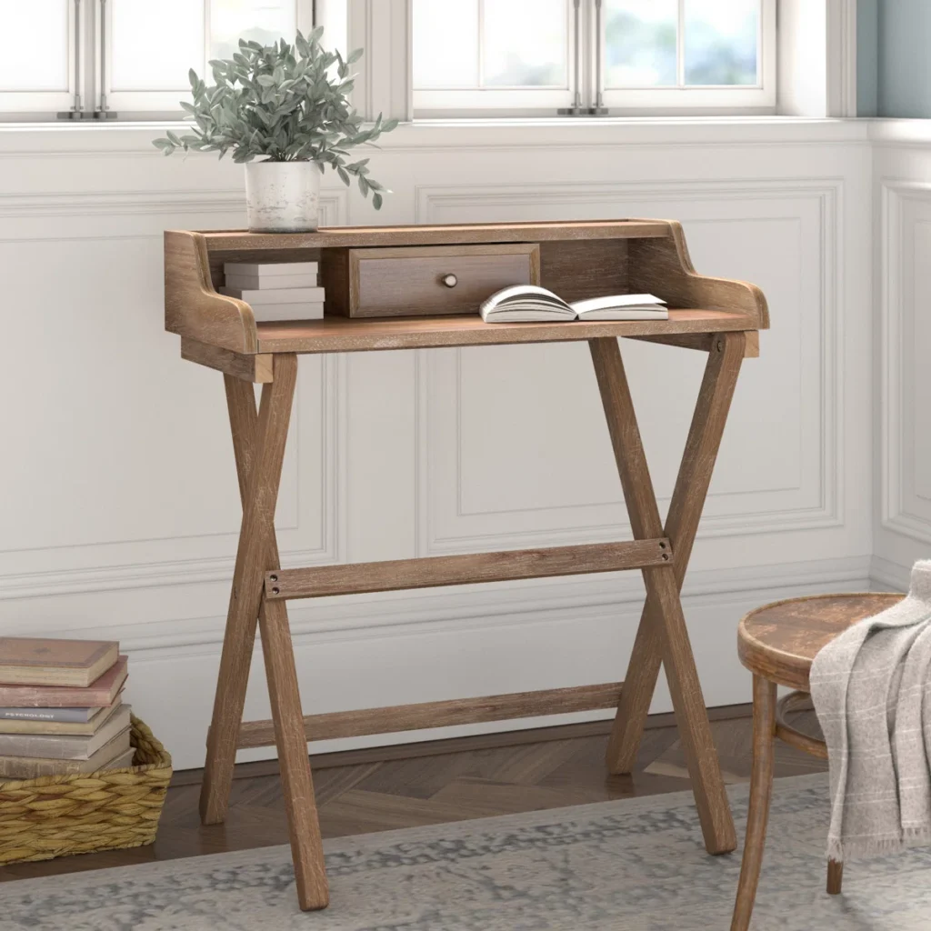 Fold-down wall-mounted desk with drawer and shelf, ideal for small home office setups.