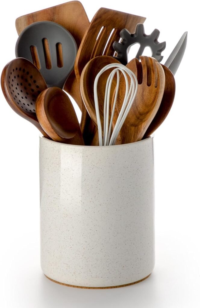Cream-colored ceramic utensil holder with wooden utensils