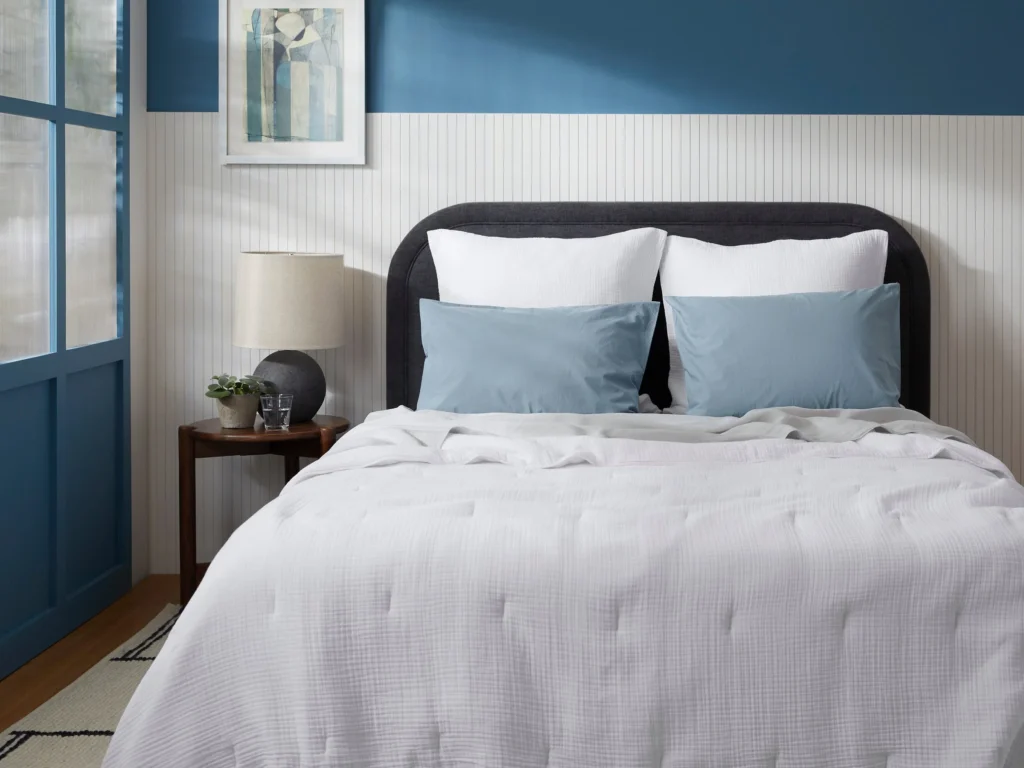 White organic cotton quilt on bed in modern room
