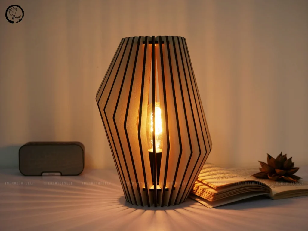 Wooden geometric table lamp lit warmly on side table
