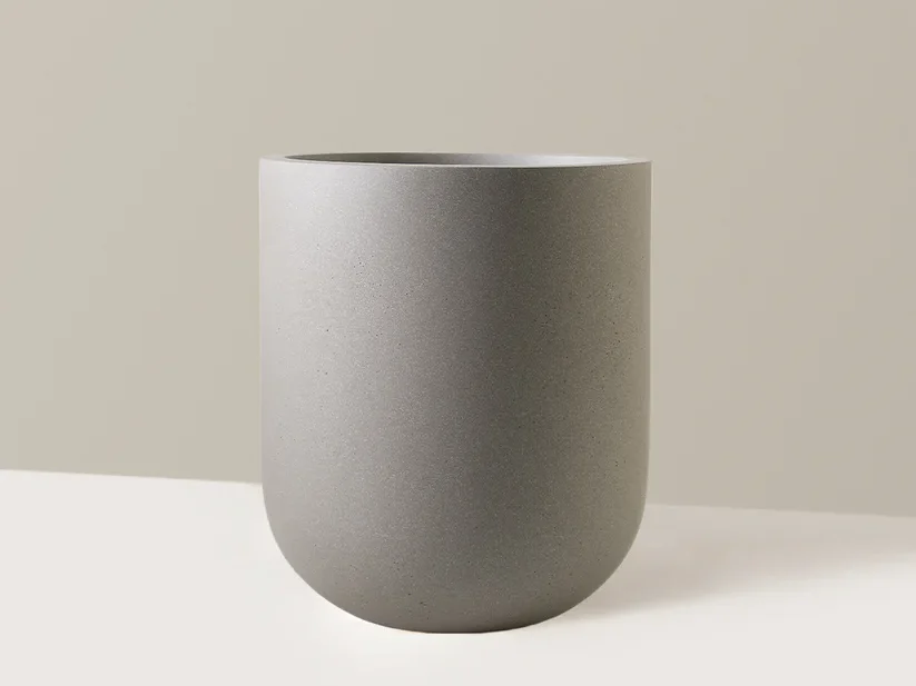 Simple, sleek ceramic planter in matte grey finish.