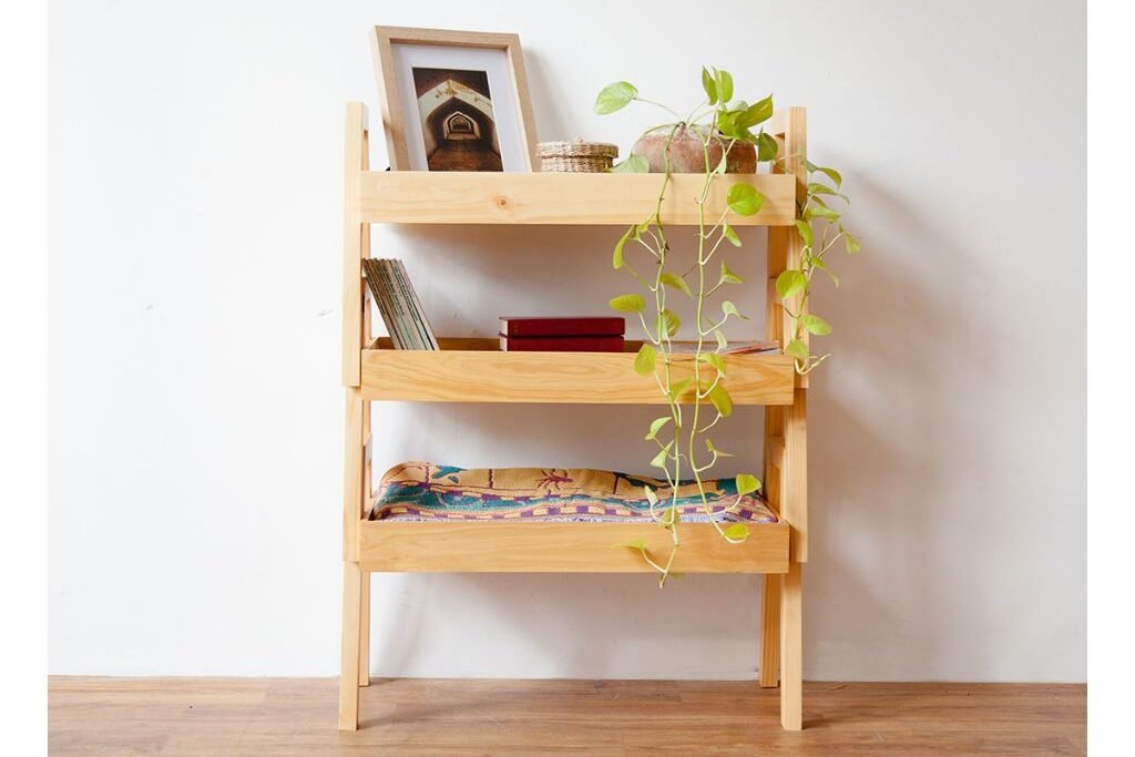 Small bamboo shelving unit with potted plant and accessories