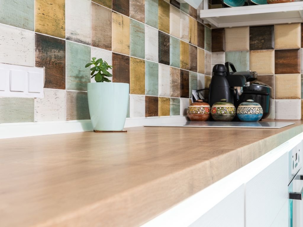 Coffee counter with colorful tile backsplash and minimal decor