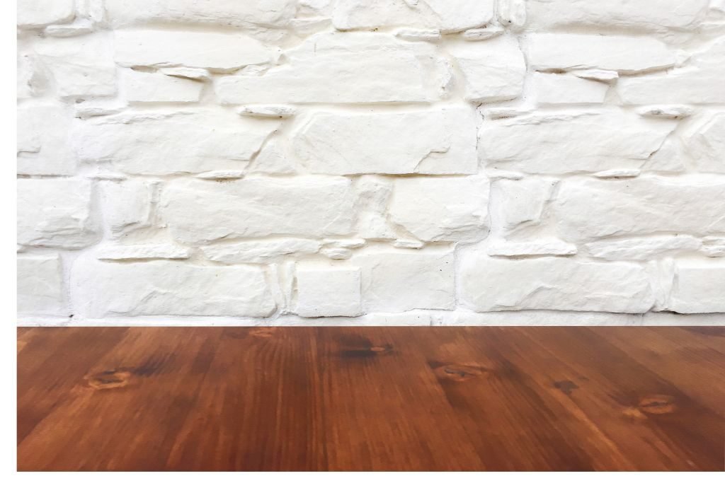 White textured brick wall with rich wood flooring