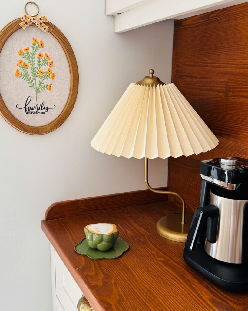 Coffee machine with a table lamp and framed embroidery
