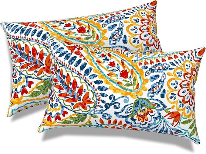 Colorful embroidered pillows stacked together