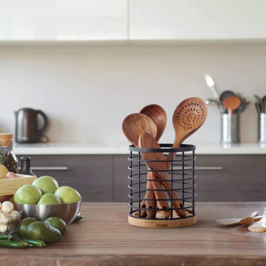 Black utensil holder with wooden base and tools inside
