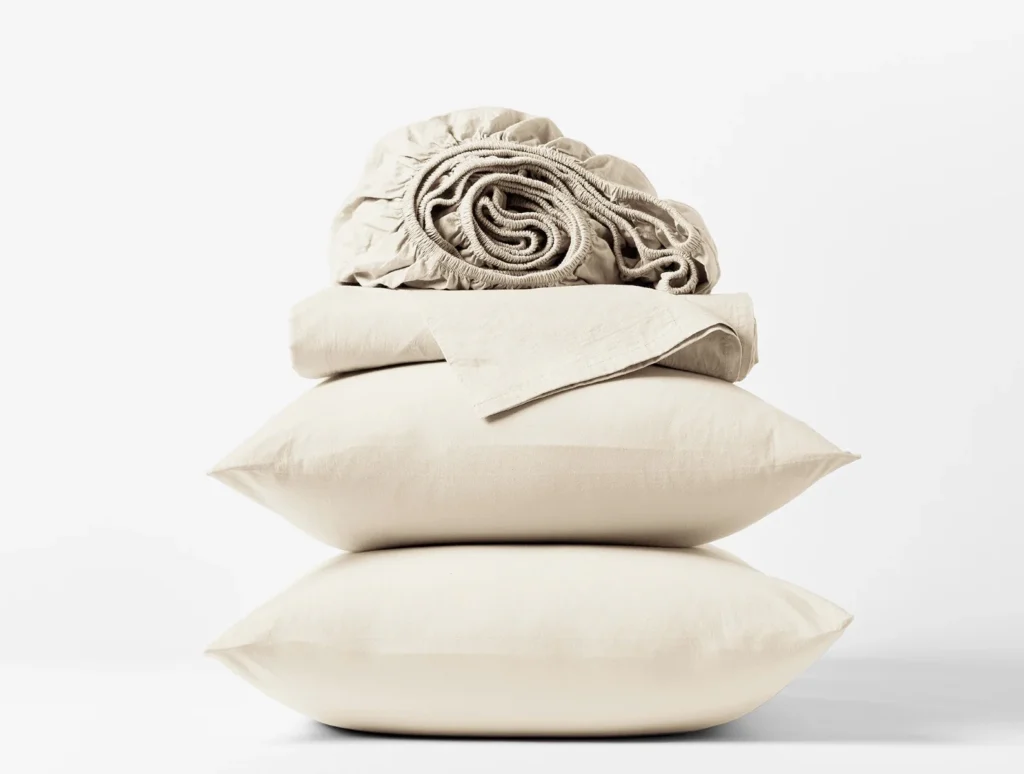 Organic crinkled percale sheets and pillows, arranged for a cozy, eco-friendly bedroom.