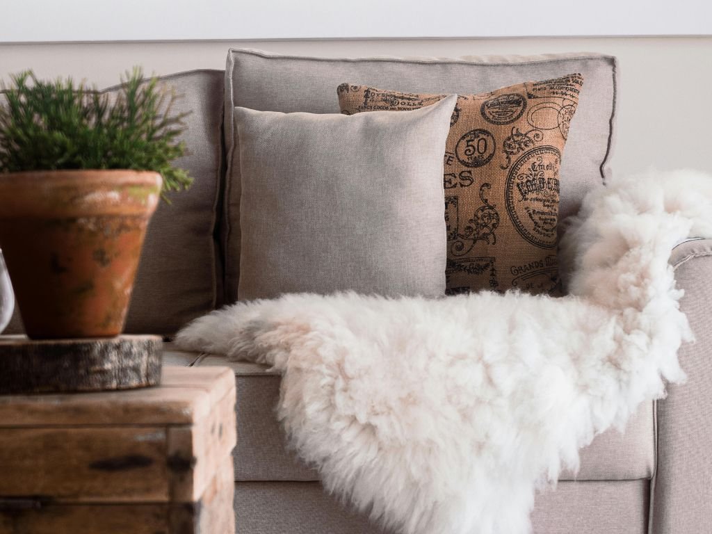 Sofa with textured pillows and soft throw