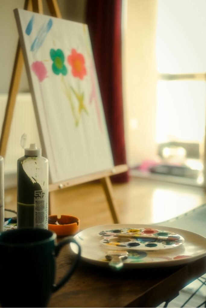 Art easel with bright flower painting and palette