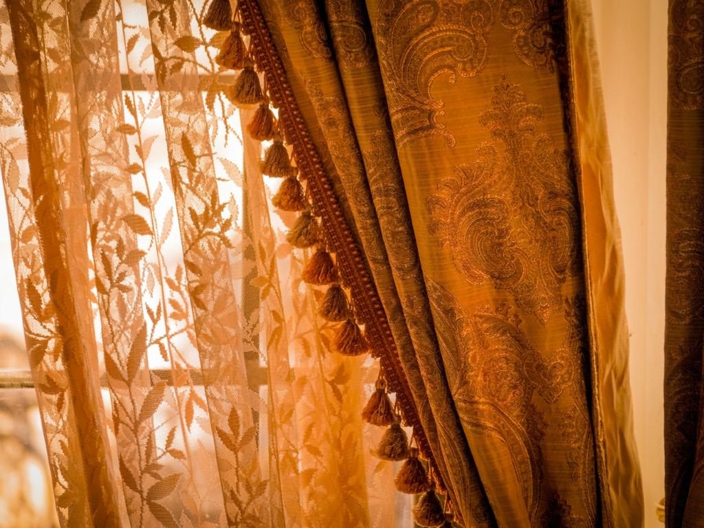 Golden velvet drapes glowing in natural autumn light.