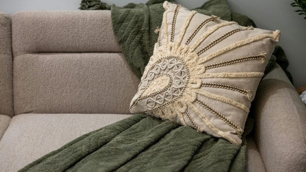 Sofa with knit pillow and green throw