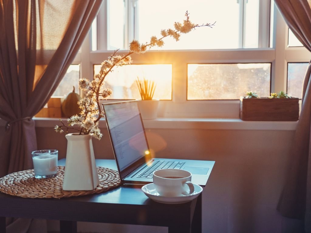 Book and coffee by the window at sunset.